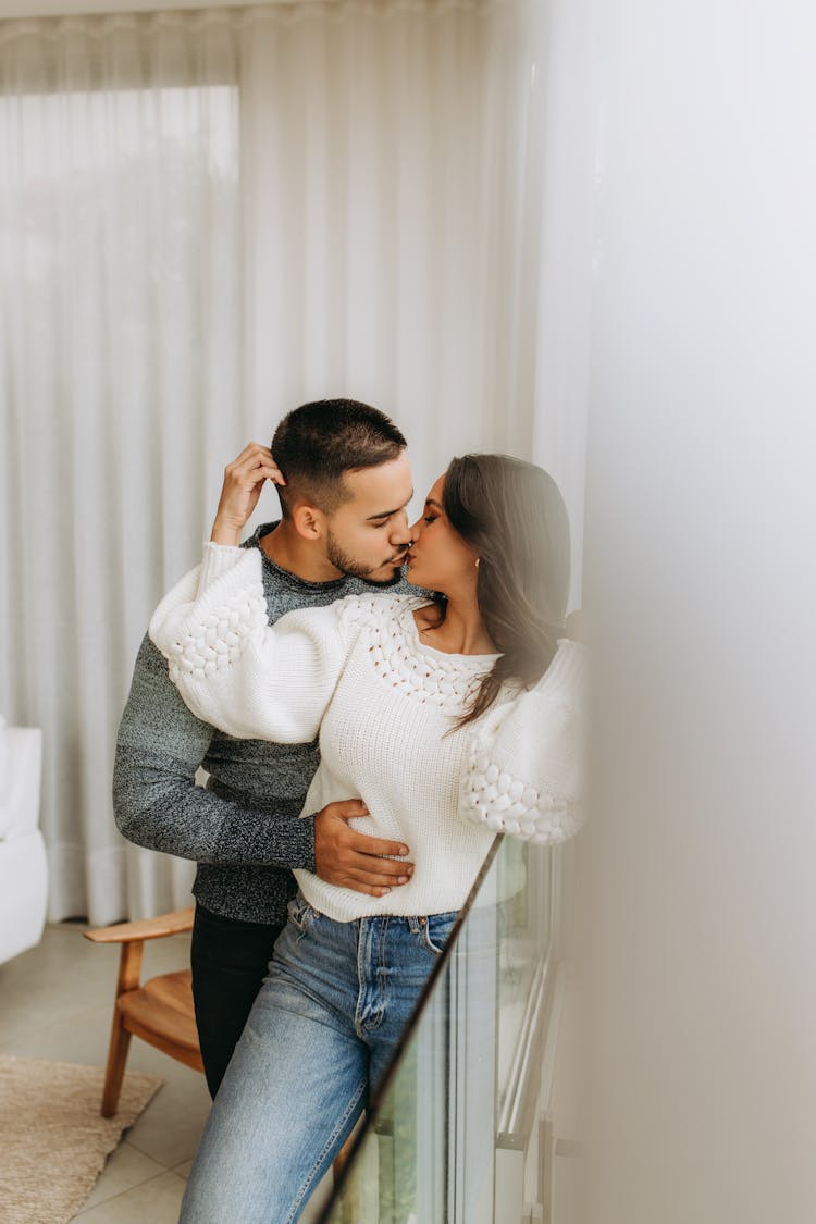 Woman And Man Standing And Kissing