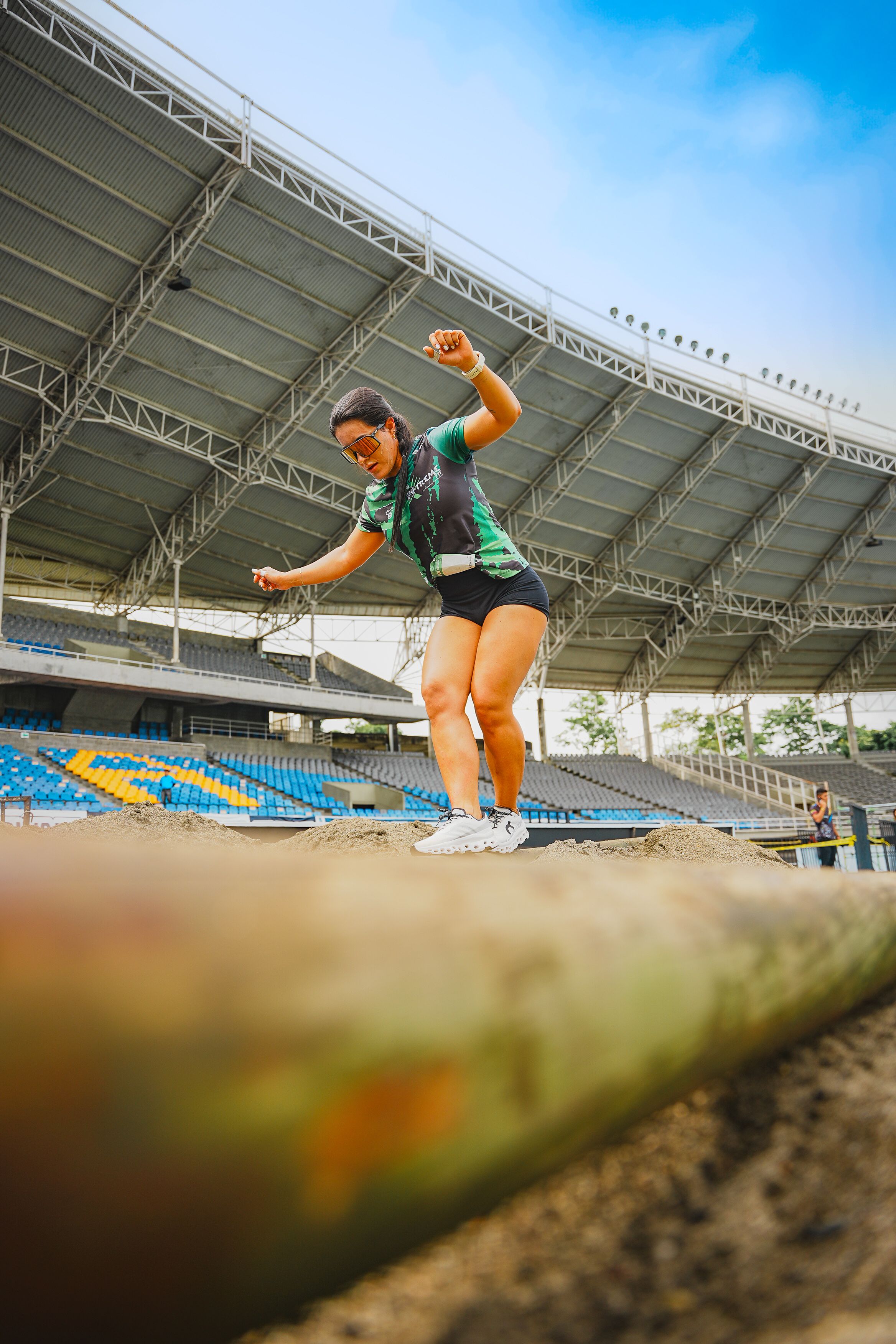 Woman Athlete Training Long Jump on Stadium · Free Stock Photo