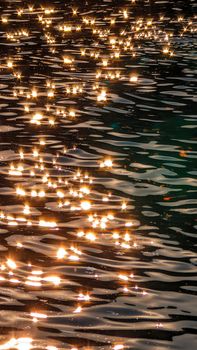 Captivating sunlight reflections on dynamic water ripples, creating a shimmering golden effect.