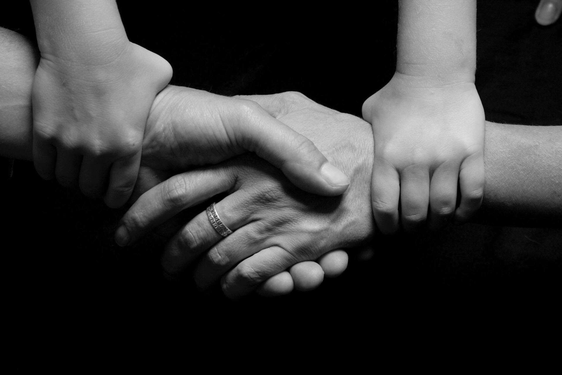 children holding hands black and white