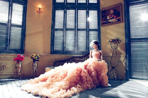 Free Woman Sitting Bench Near Window Stock Photo