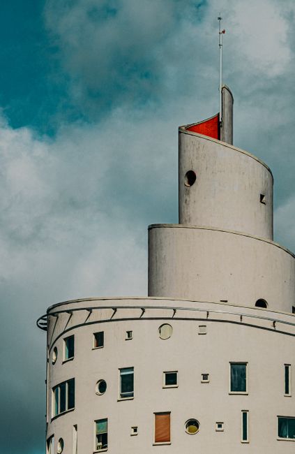 The iconic Snail Tower in Tartu, Estonia, showcasing unique architectural design against a dramatic sky.