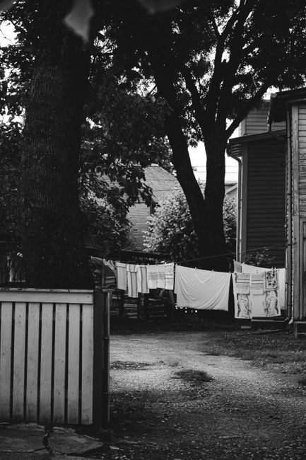 Photo by Kurt Smith on Pexels Black and white photo of laundry drying on a clothesline in a shaded yard.