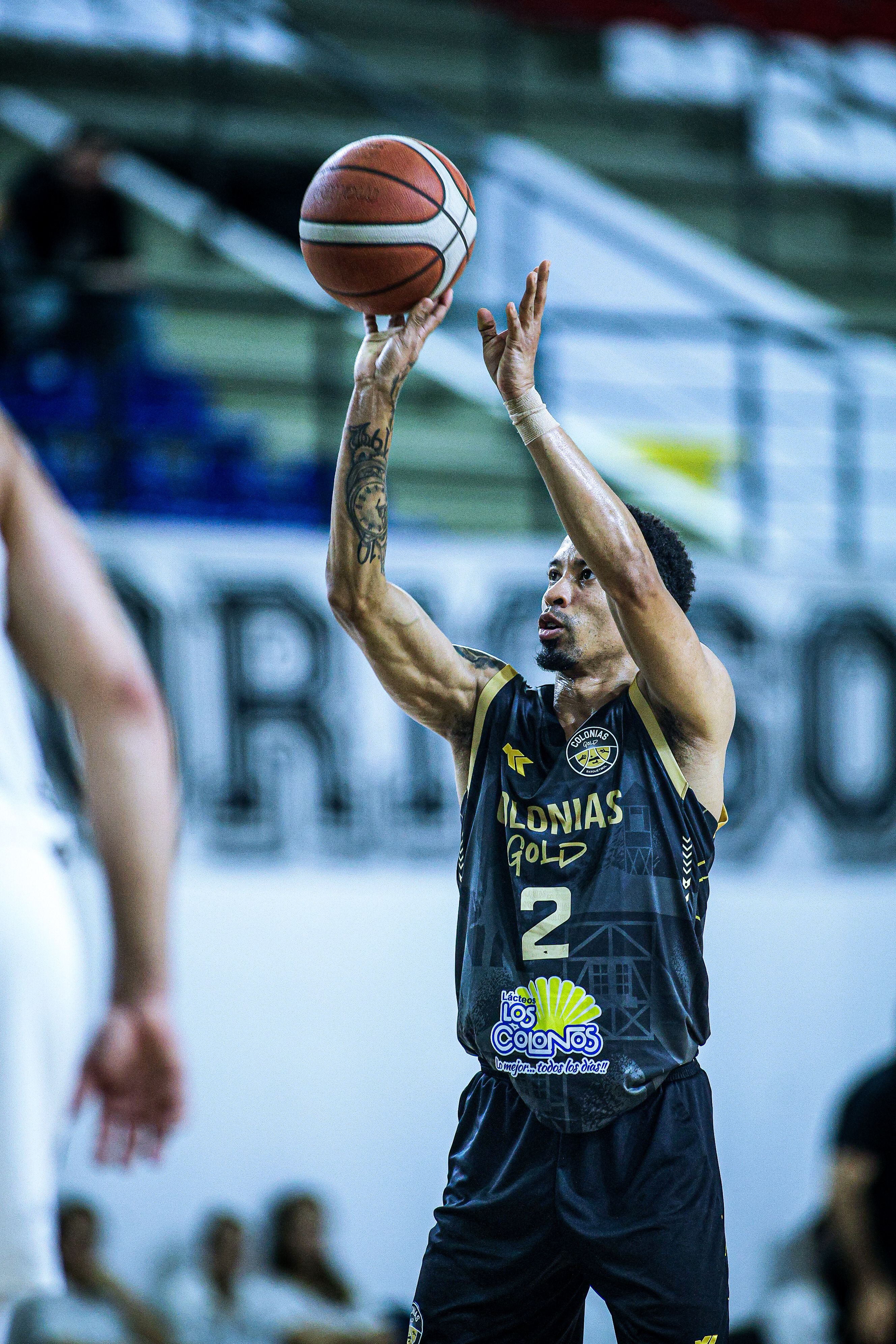 Dynamic action shot of a basketball player shooting during a game in Paraguay.