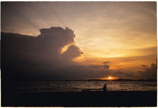 A stunning sunset at Vung Tau beach, showcasing dramatic clouds and serene coastal beauty.