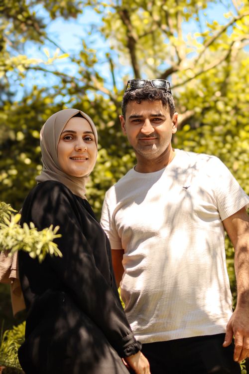 Free A happy couple enjoying a sunny day in a lush green park. Stock Photo
