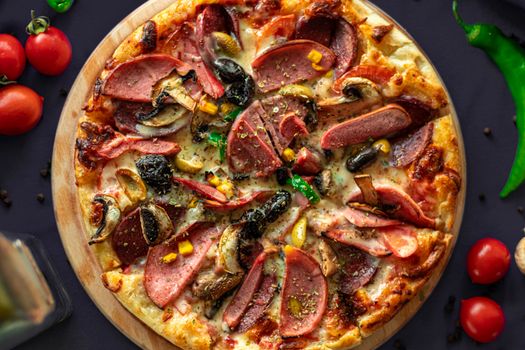 Top view of a freshly baked pizza with meat and vegetables, perfect for food photography lovers.