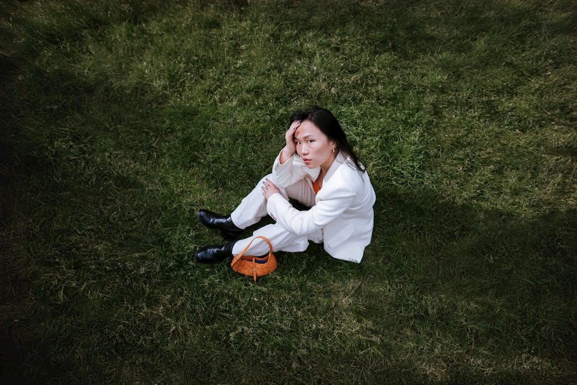 Free woman sitting on the grass  Stock Photo