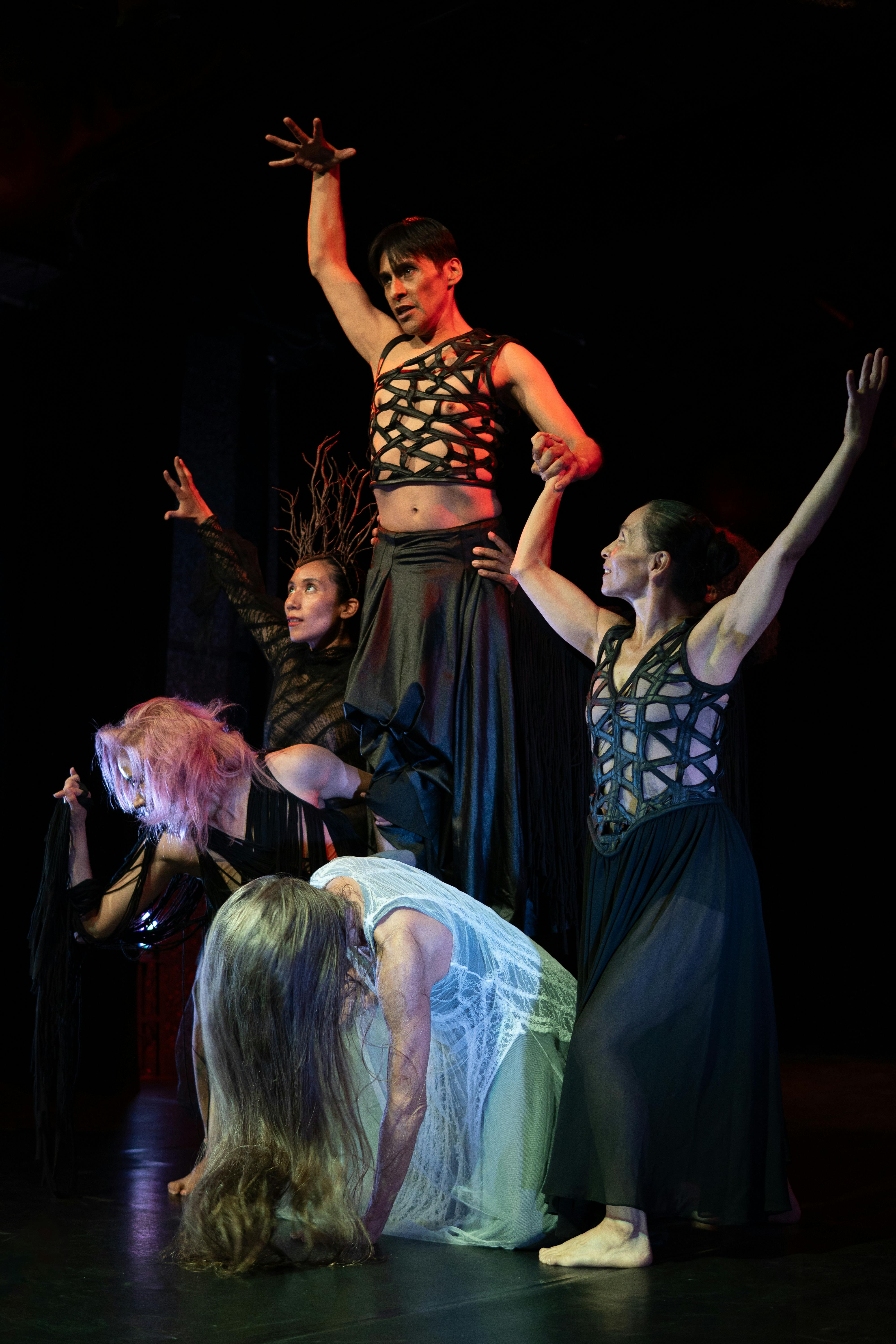 Free Energetic dance ensemble performing on a dark stage in Mexico City theater. Stock Photo