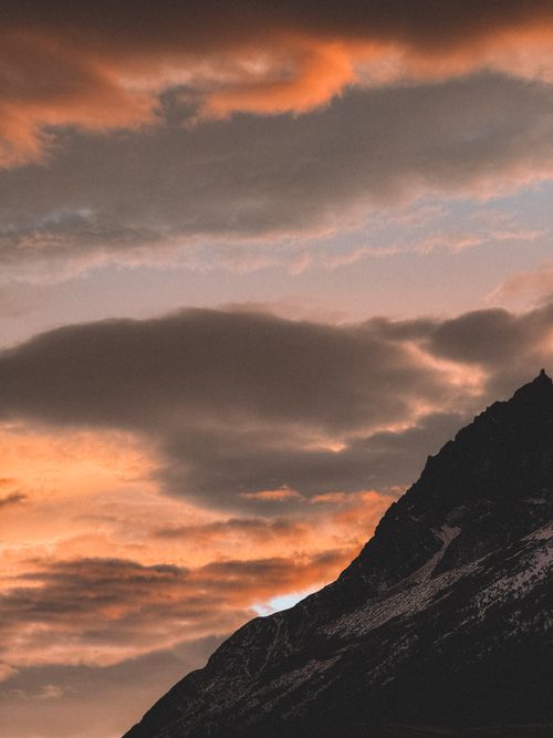 Free Majestic clouds and sunset hues over mountains in Chile's Magallanes region. Stock Photo