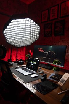 A stylish, organized desk setup with advanced technology and lighting, perfect for a modern work environment.