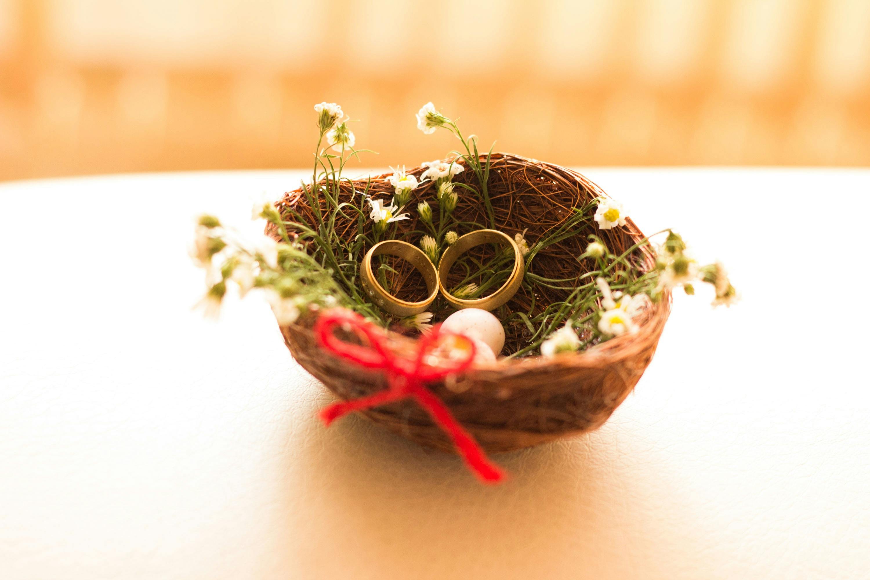 selective focus photography of gold colored wedding band