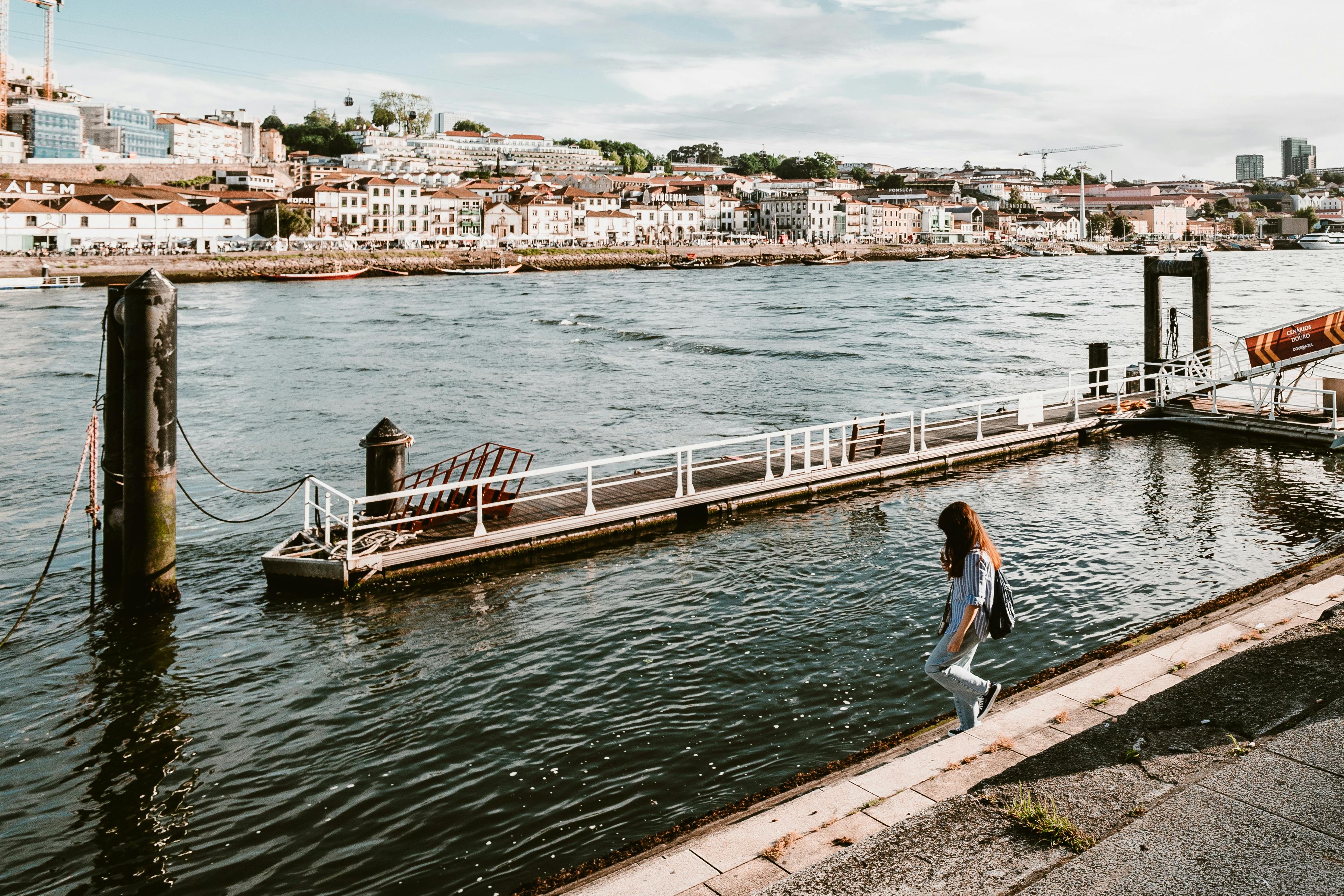 A woman exploring the historic waterfront of Stone Town, Zanzibar - safe beach destinations for solo female travellers