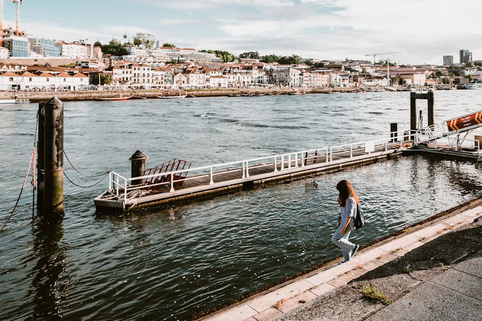 A woman exploring the historic waterfront of Stone Town, Zanzibar - safe beach destinations for solo female travellers A woman exploring the historic waterfront of Stone Town, Zanzibar - safe beach destinations for solo female travellers