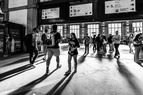 Free Black and white photo capturing people walking inside Sao Bento Railway Station in Porto, Portugal. Stock Photo