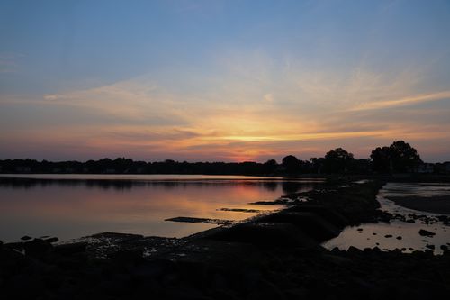 Free Calm sunset scene over a tranquil lake in Stamford, Connecticut, showcasing vibrant colors and reflections. Stock Photo