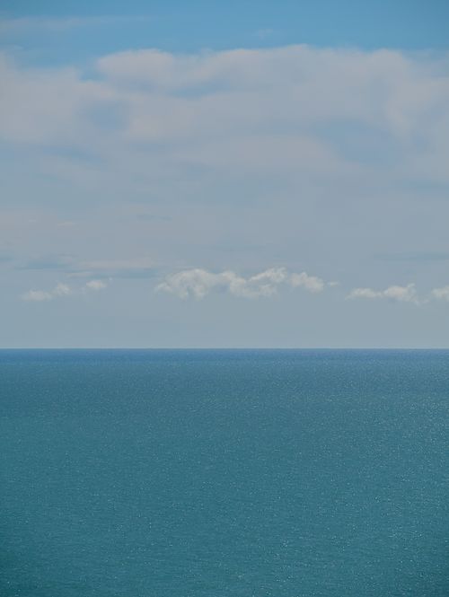 Free Peaceful ocean view with a clear horizon and cloudy sky. Perfect for relaxation and serenity themes. Stock Photo