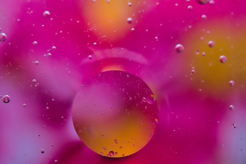 Free Captivating close-up shot of pink and yellow bubbles creating an abstract art effect. Stock Photo
