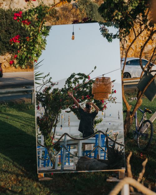 Free A creative outdoor mirror display reflecting natural scenery and decor elements. Stock Photo