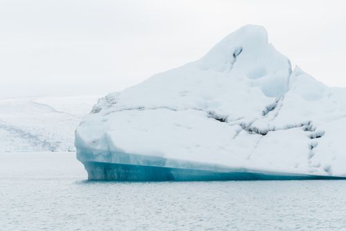 Free A solitary iceberg floats in the cold waters of Iceland, showcasing nature's icy beauty. Stock Photo