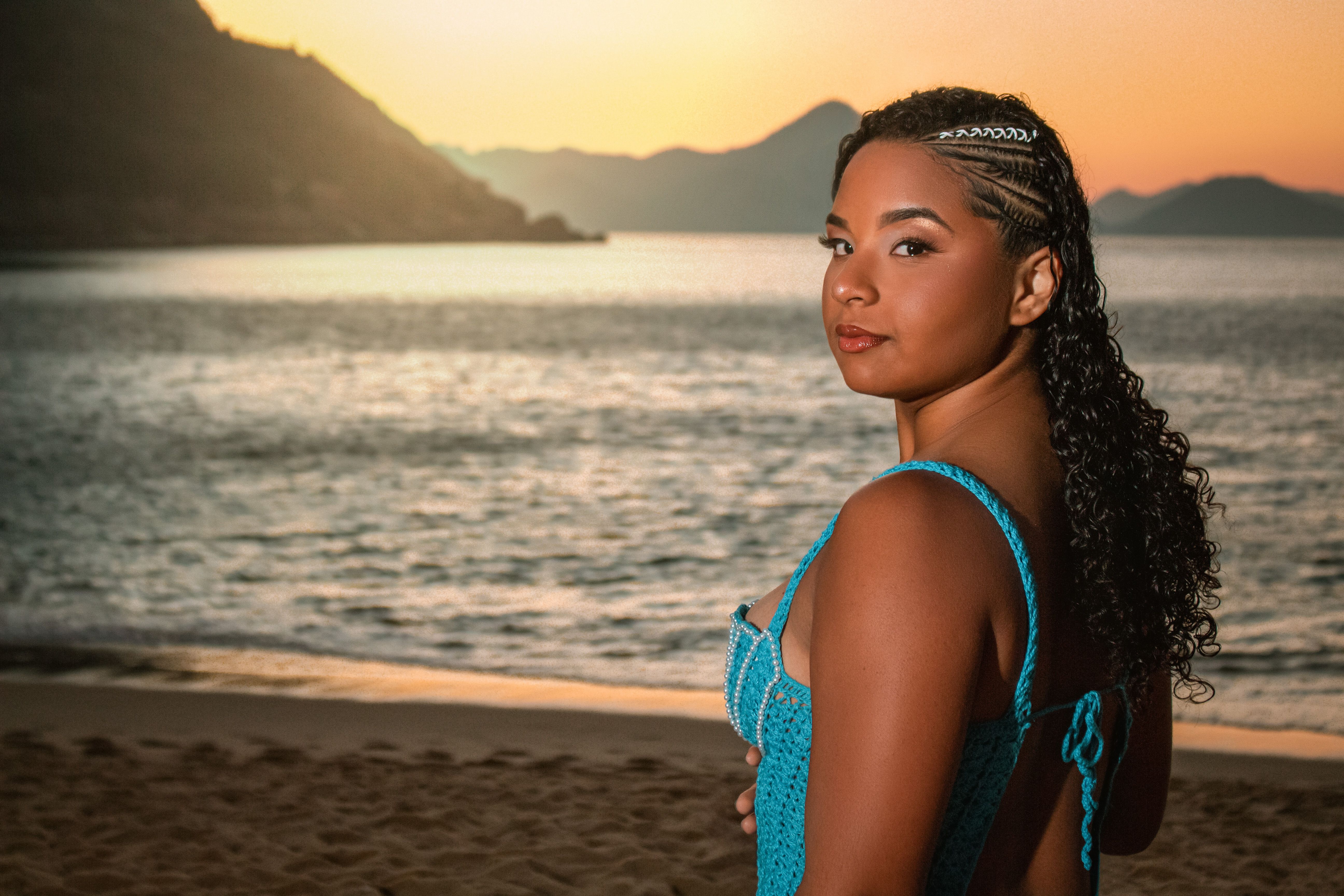 A beautiful woman in a blue swimsuit standing on the beach · Free Stock ...