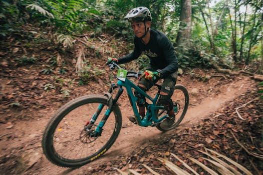Experience the thrill of mountain biking through dense forests, showcasing speed and adrenaline.
