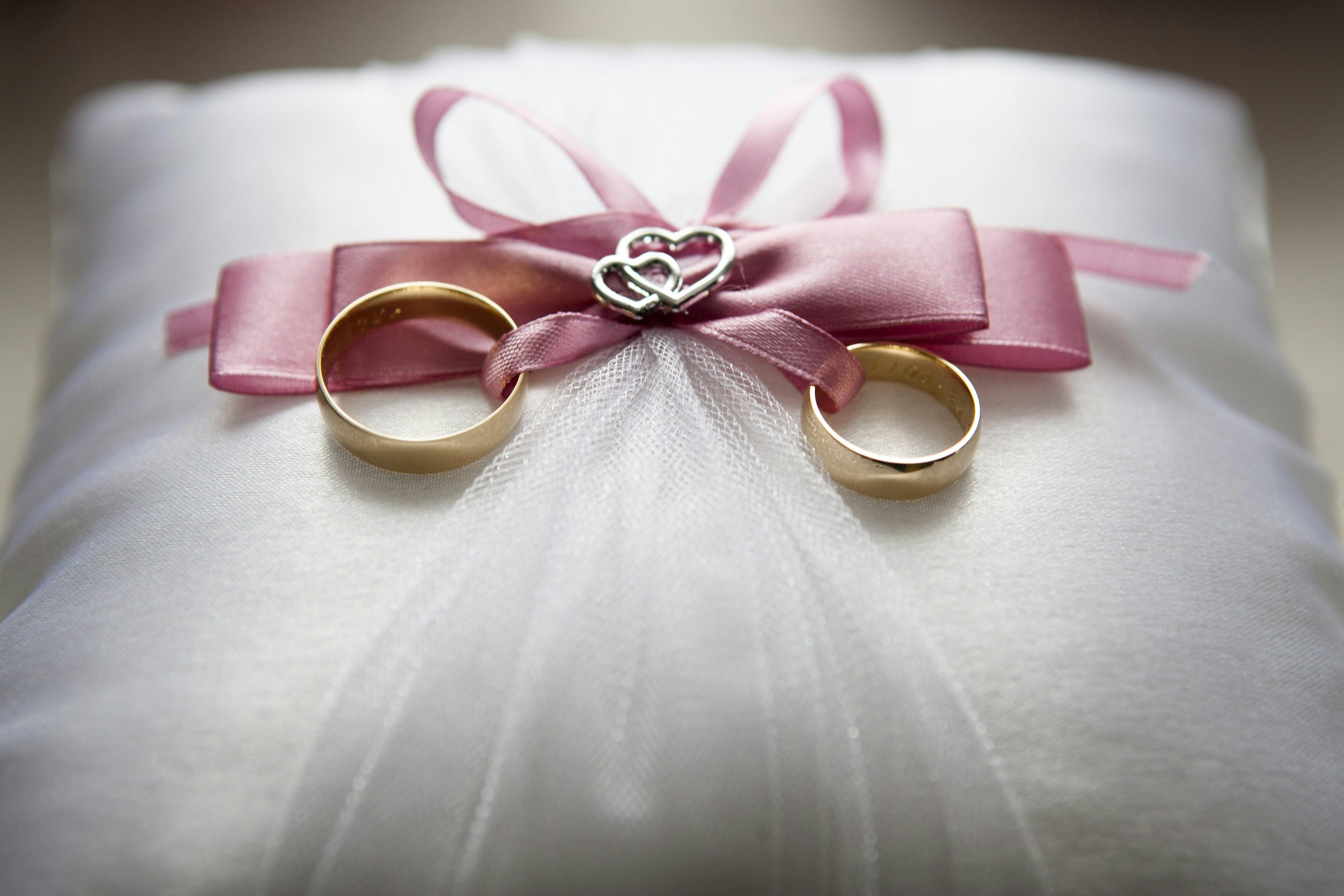 Selective Focus Photography of Silver-colored Engagement Ring Set With Pink  Bow Accent on Throw Pillow · Free Stock Photo