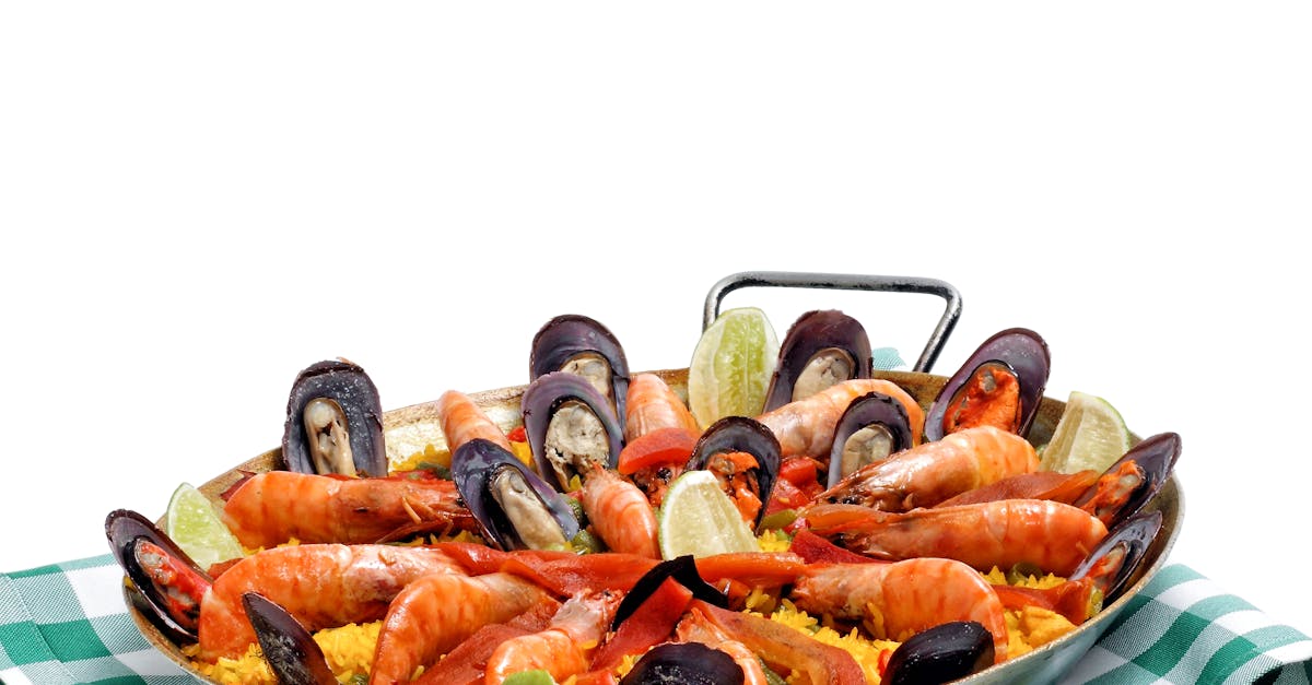 A steaming paella pan filled with a colorful mix of rice, seafood, chorizo, and vegetables.