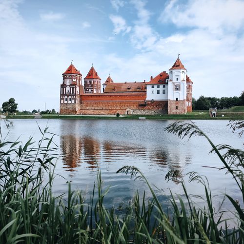Free Scenic view of Mir Castle, a UNESCO World Heritage site, reflected in a serene lake in Belarus. Stock Photo