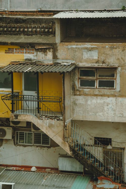 Free Weathered building facade captures urban decay in Ho Chi Minh City. Stock Photo
