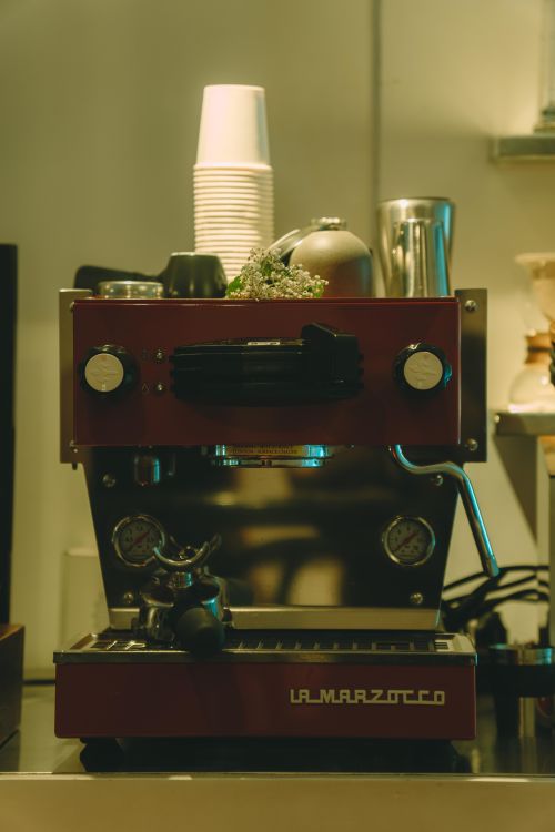 Free A warm-toned image of a La Marzocco espresso machine in a cozy Ho Chi Minh City coffee shop. Stock Photo