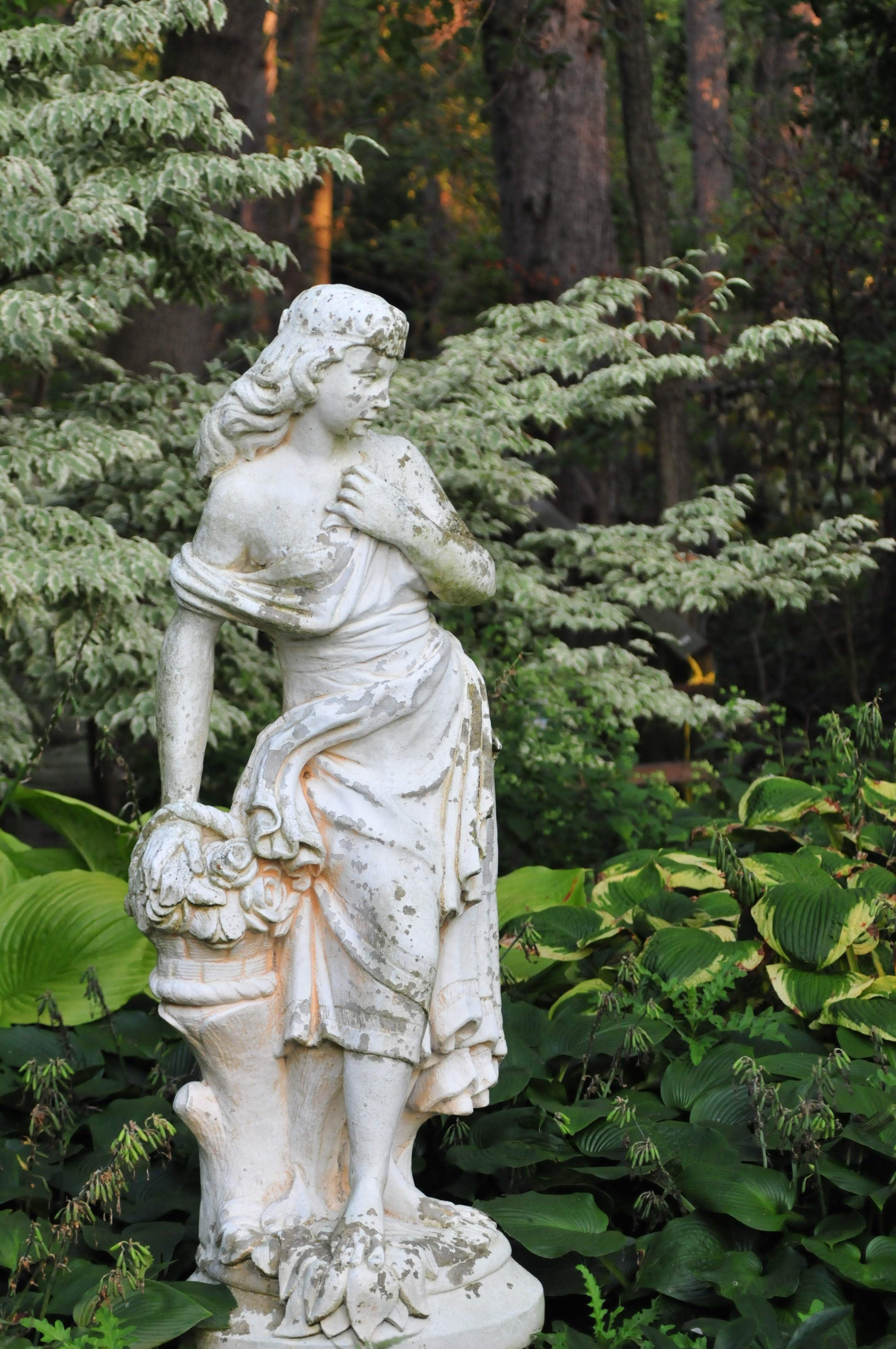 Stone Woman Statue in Garden between Trees · Free Stock Photo