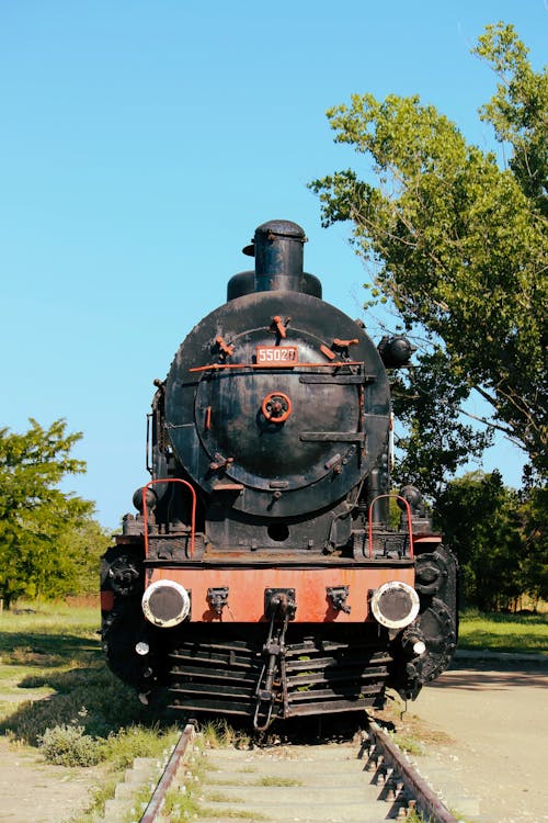 An old train engine is parked on the tracks