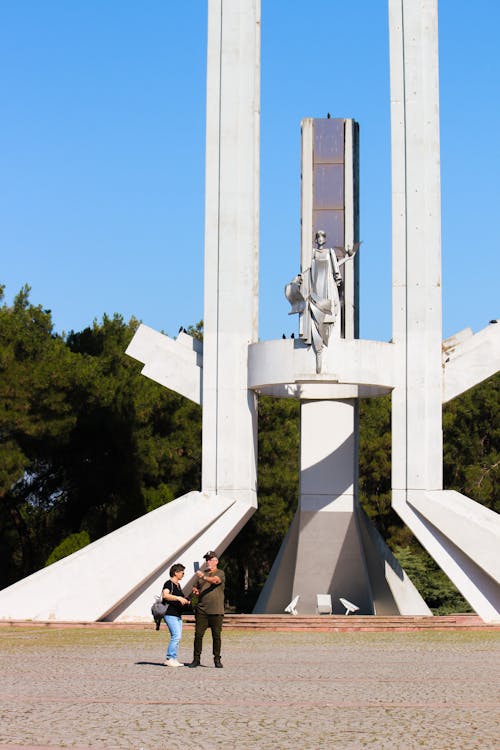 Two people standing in front of a monument