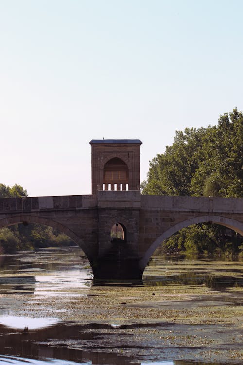 A bridge over a river with a clock tower