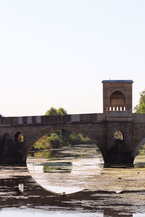 A bridge over a river with a clock tower