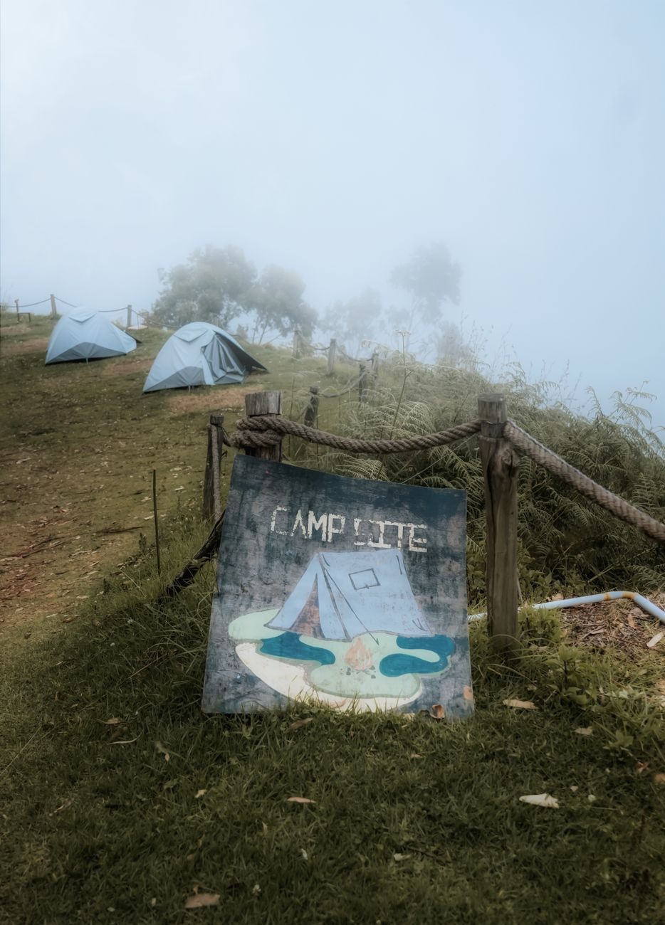 Cold-weather campsite with tents on grassy hills, the kind of trip where sleeping off the ground matters
