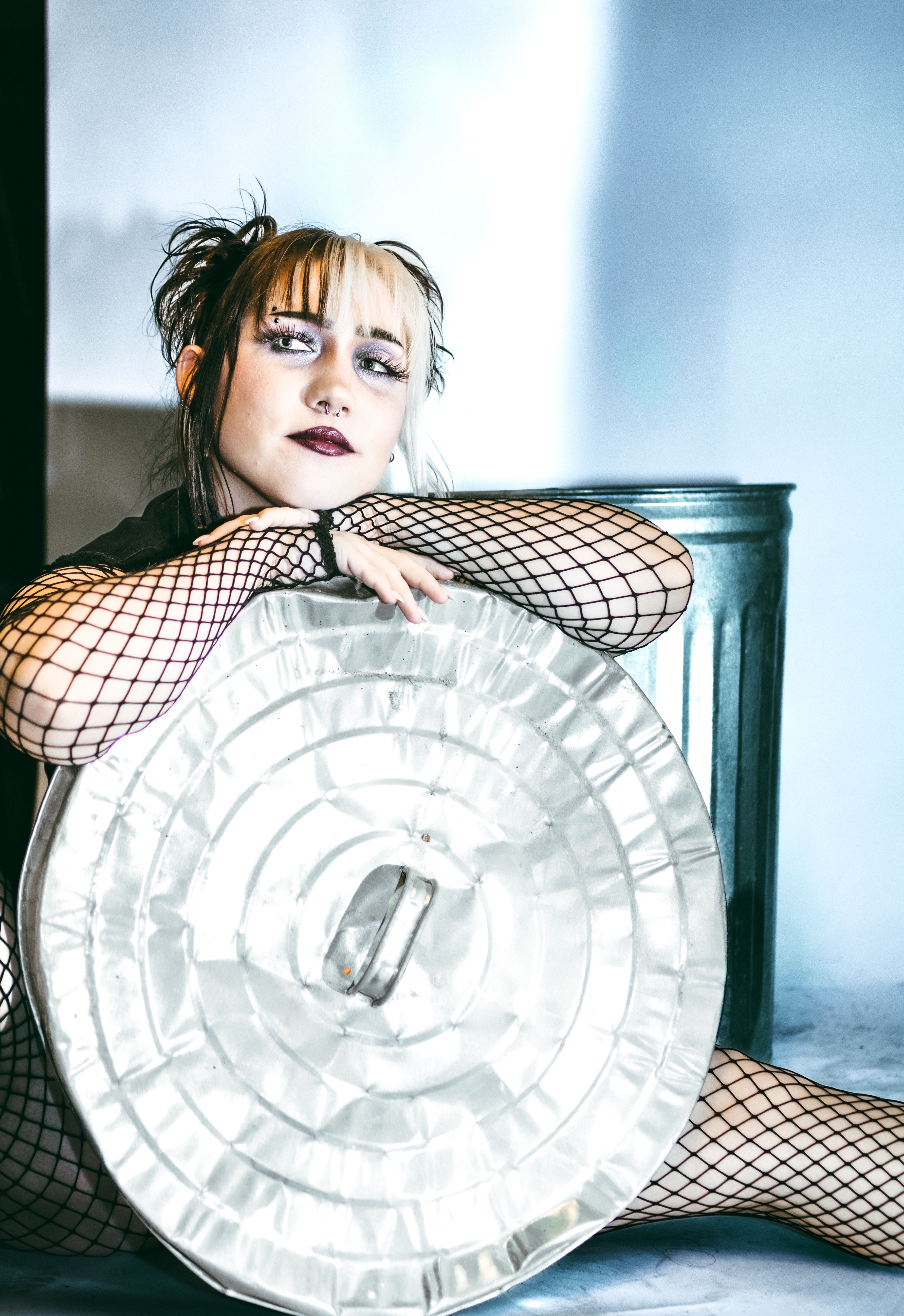 A woman in fishnets and a metal plate · Free Stock Photo