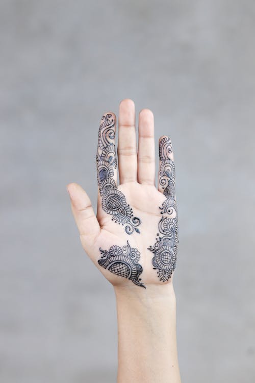 Free Photo of a Person Showing Mehndi Temporary Tattoo on the hand Palm Stock Photo