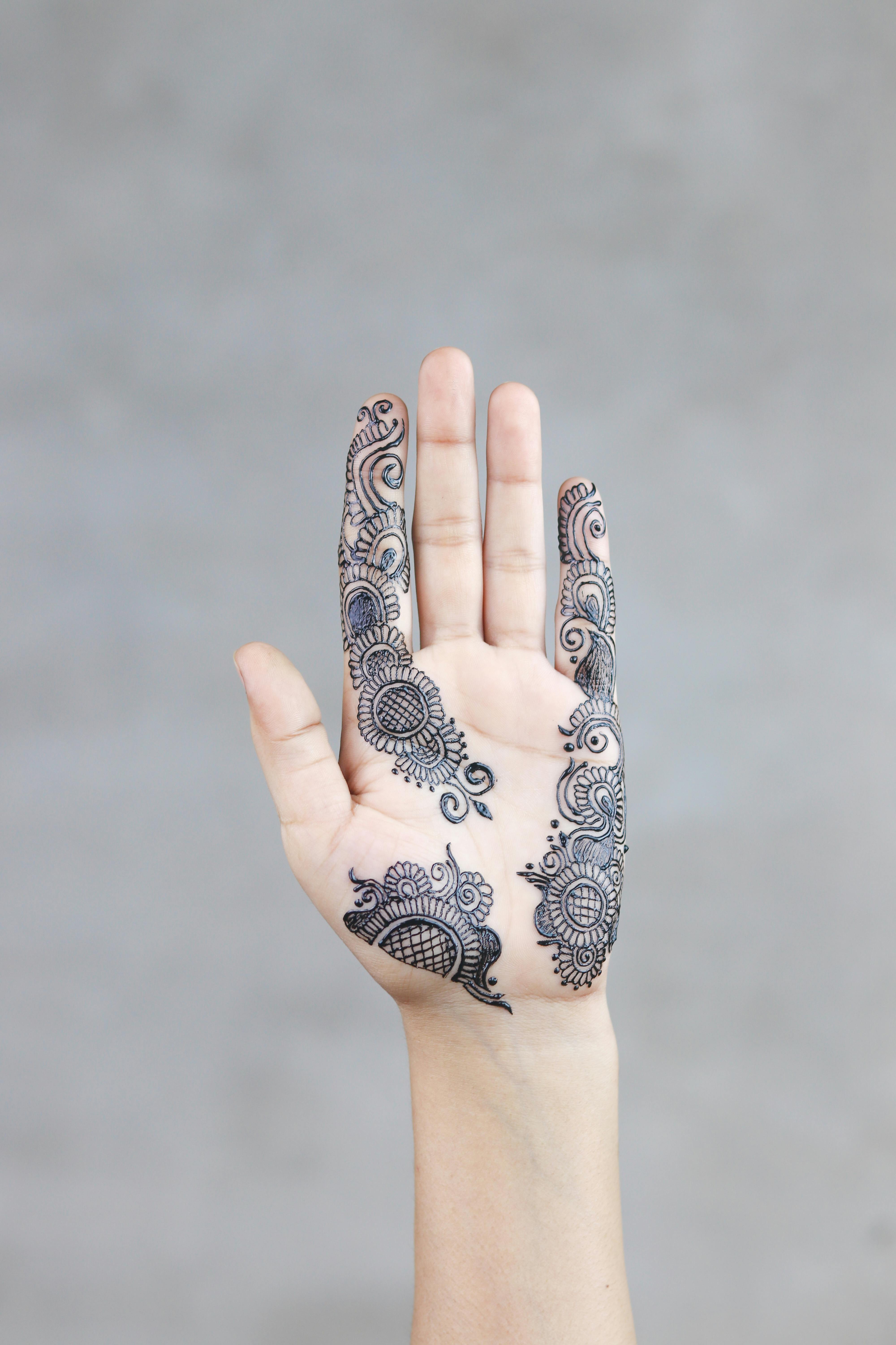 Photo Of A Person Showing Mehndi Temporary Tattoo On The Hand Palm Free Stock Photo