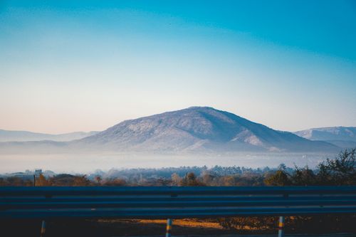 Free Misty mountain landscape during early morning with a clear blue sky. Stock Photo