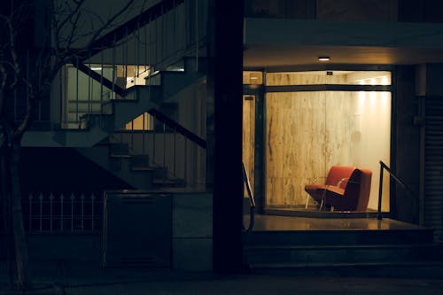 A red chair sitting in front of a building