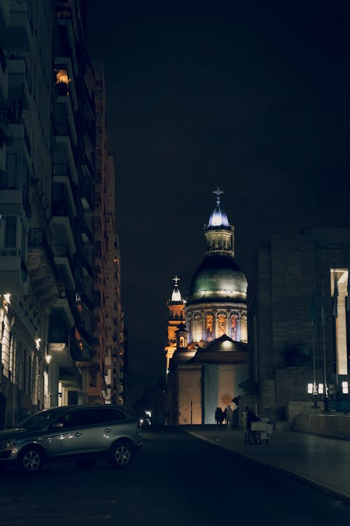 A street with a church and cars parked in front of it