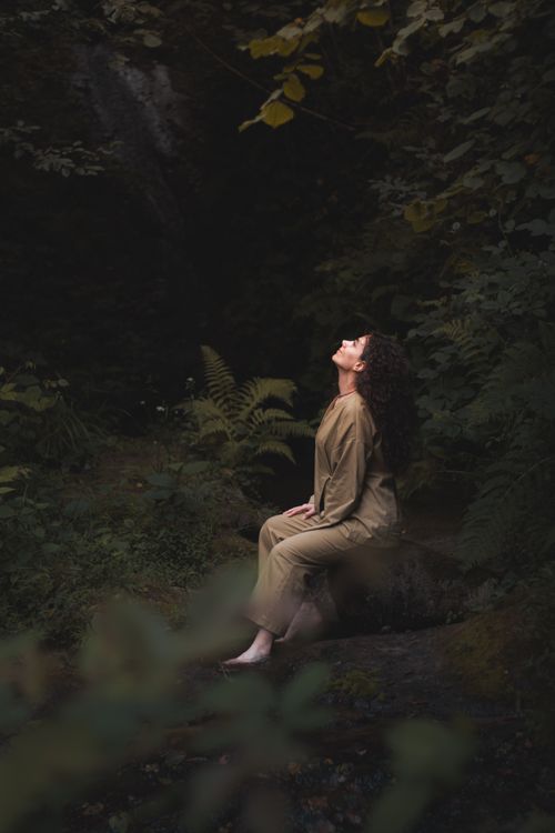 Free Young woman meditating in a tranquil forest setting, embracing nature's serenity. Stock Photo