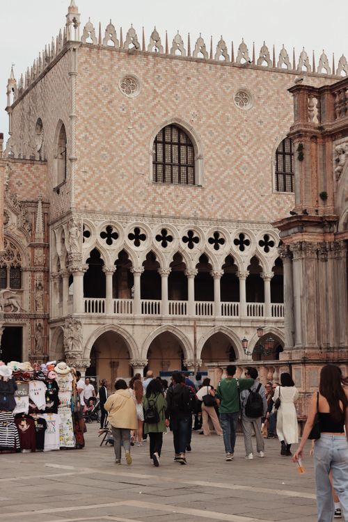 Free A bustling scene of tourists at the historic Doge's Palace in Venice, highlighting Venetian architecture. Stock Photo