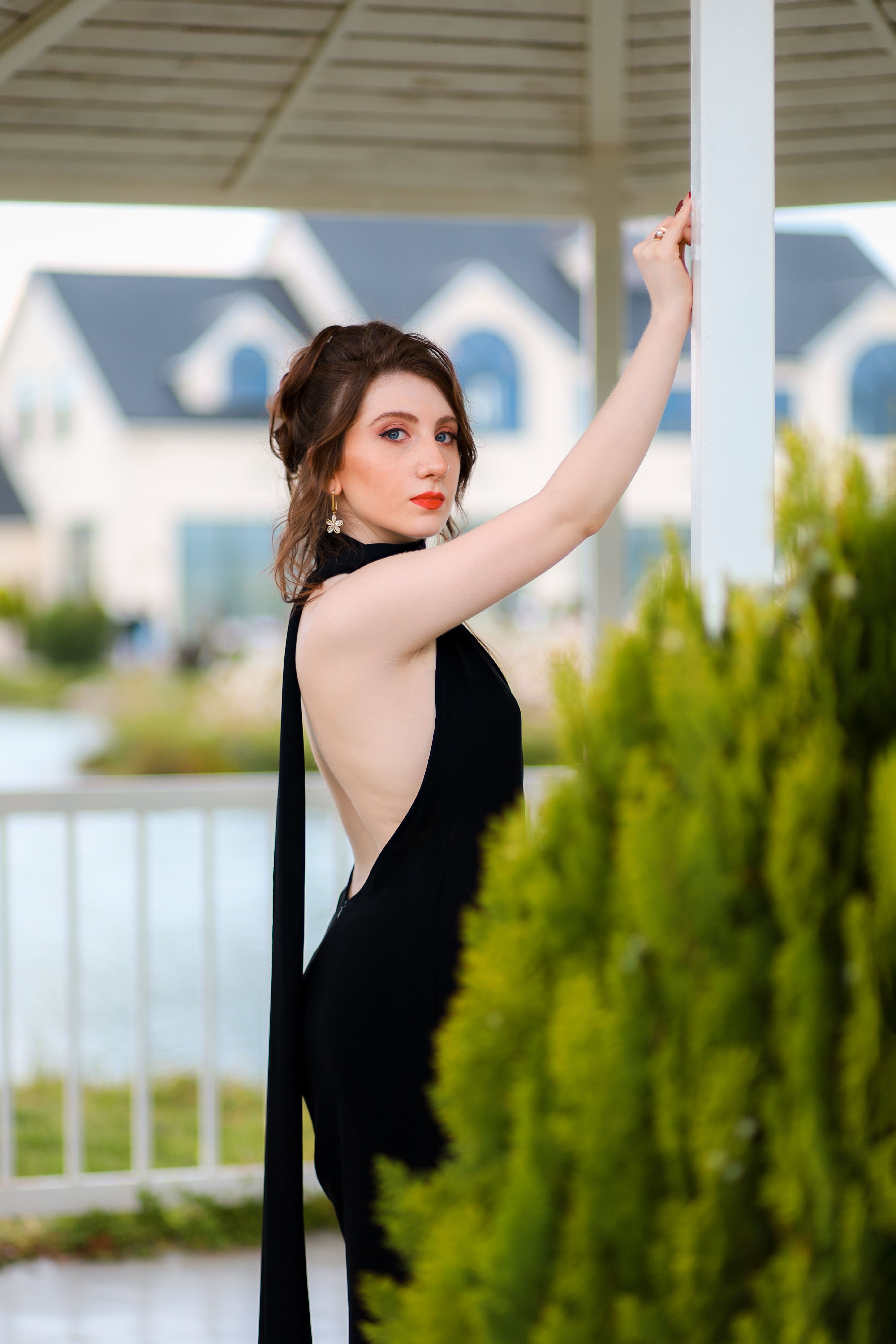 A Young Woman in a Black Dress Posing Outside · Free Stock Photo