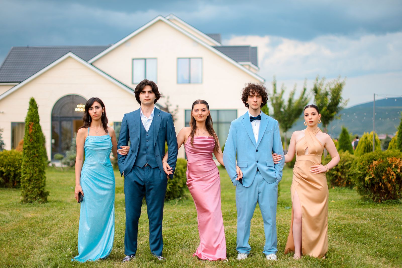 group dressed for prom posing in a garden