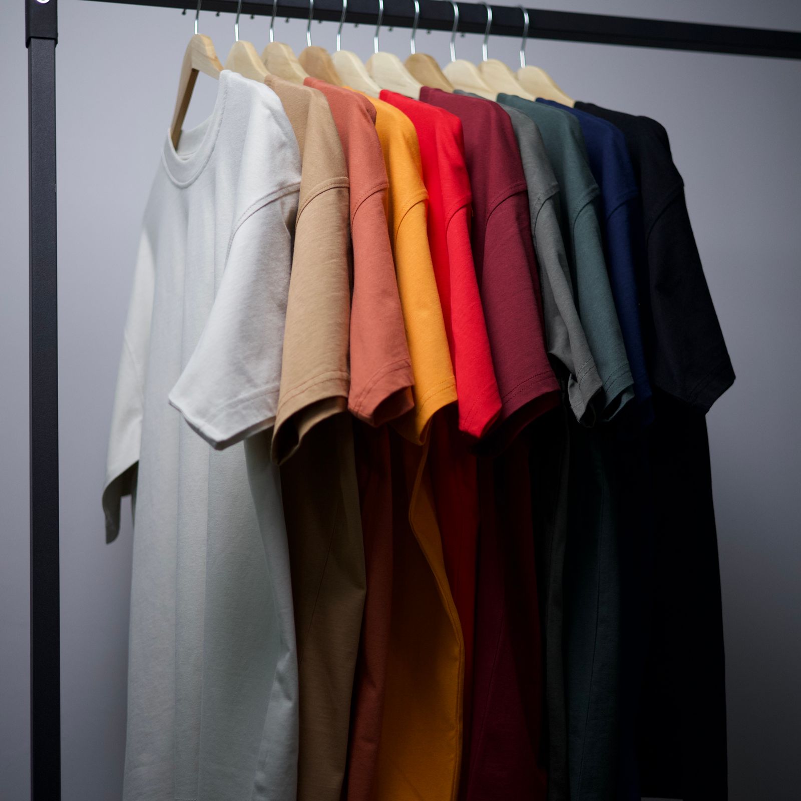 Colorful cotton T-shirts on a retail garment rack