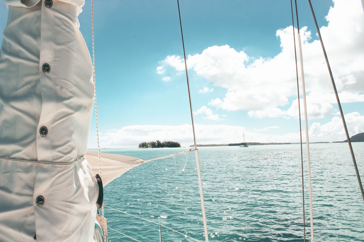 Experience the serene beauty of sailing in the clear waters of Vaitāpē, French Polynesia.