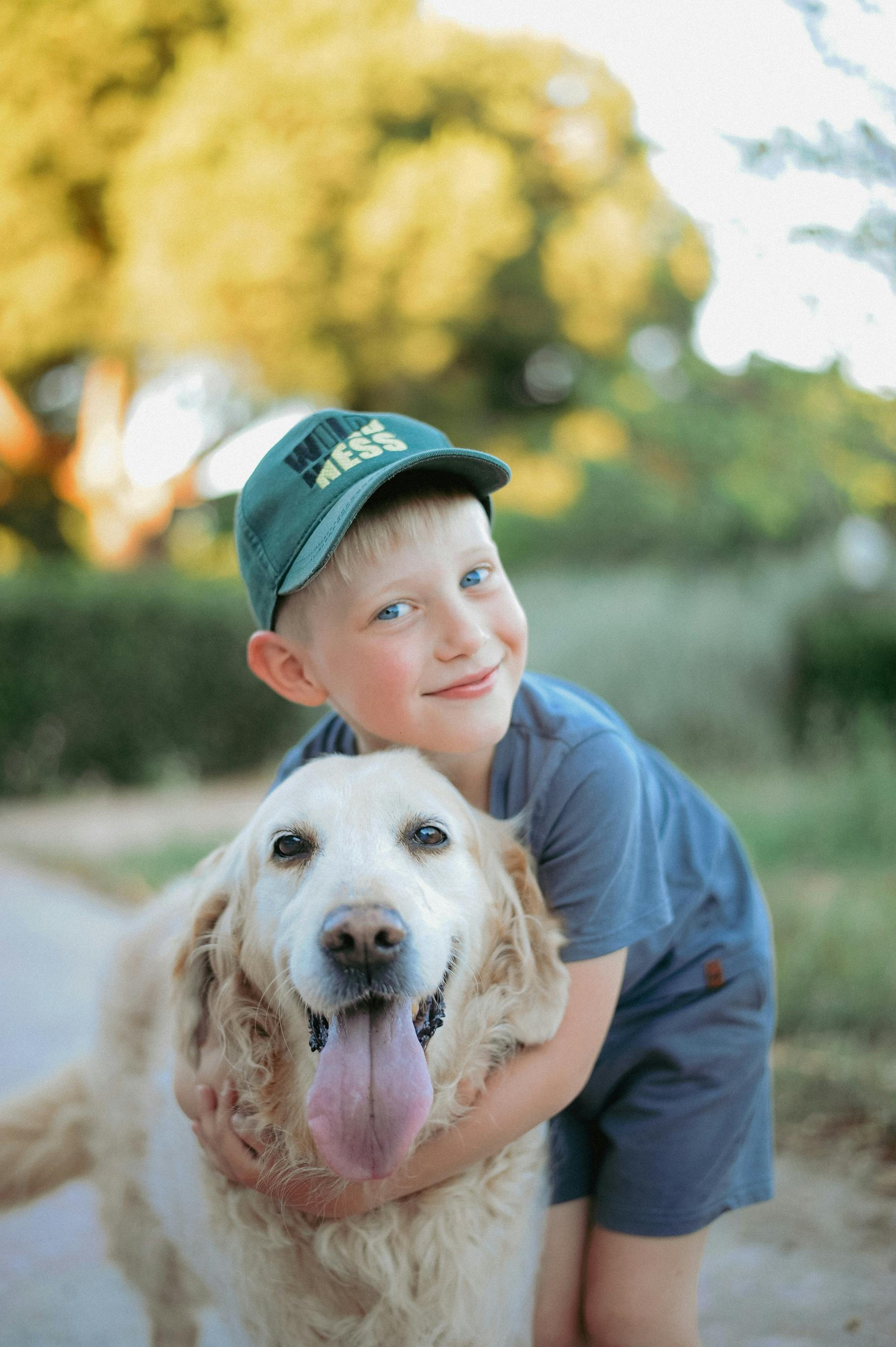 a little boy hugging his golden retriever dog